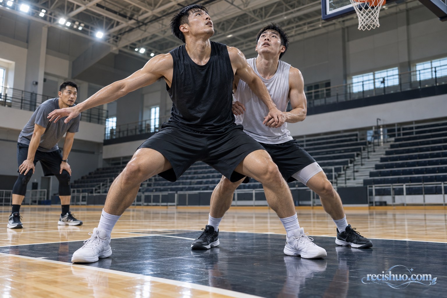 两名篮球运动员在篮下进行卡位训练并由教练观察