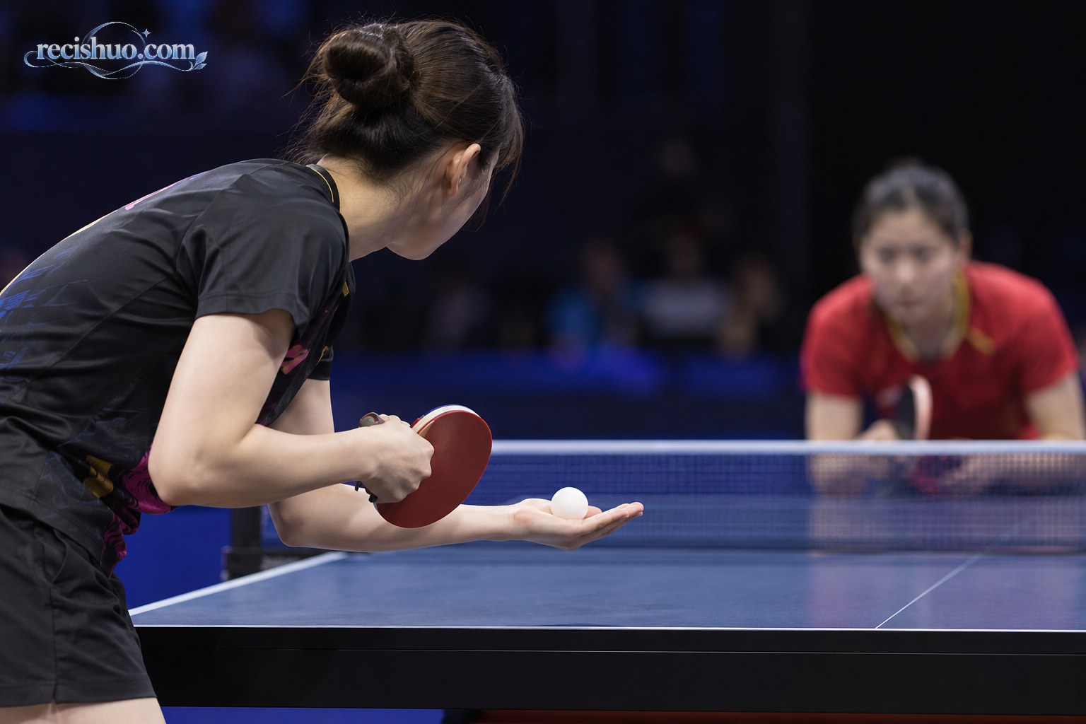 女子乒乓球运动员在发球前观察对手站位